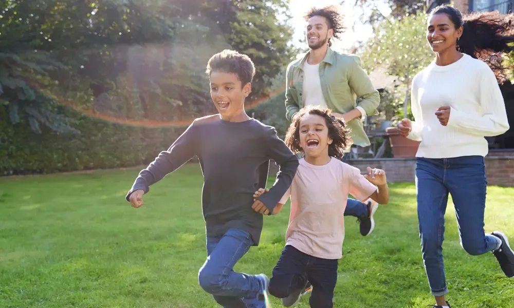 family playing in backyard